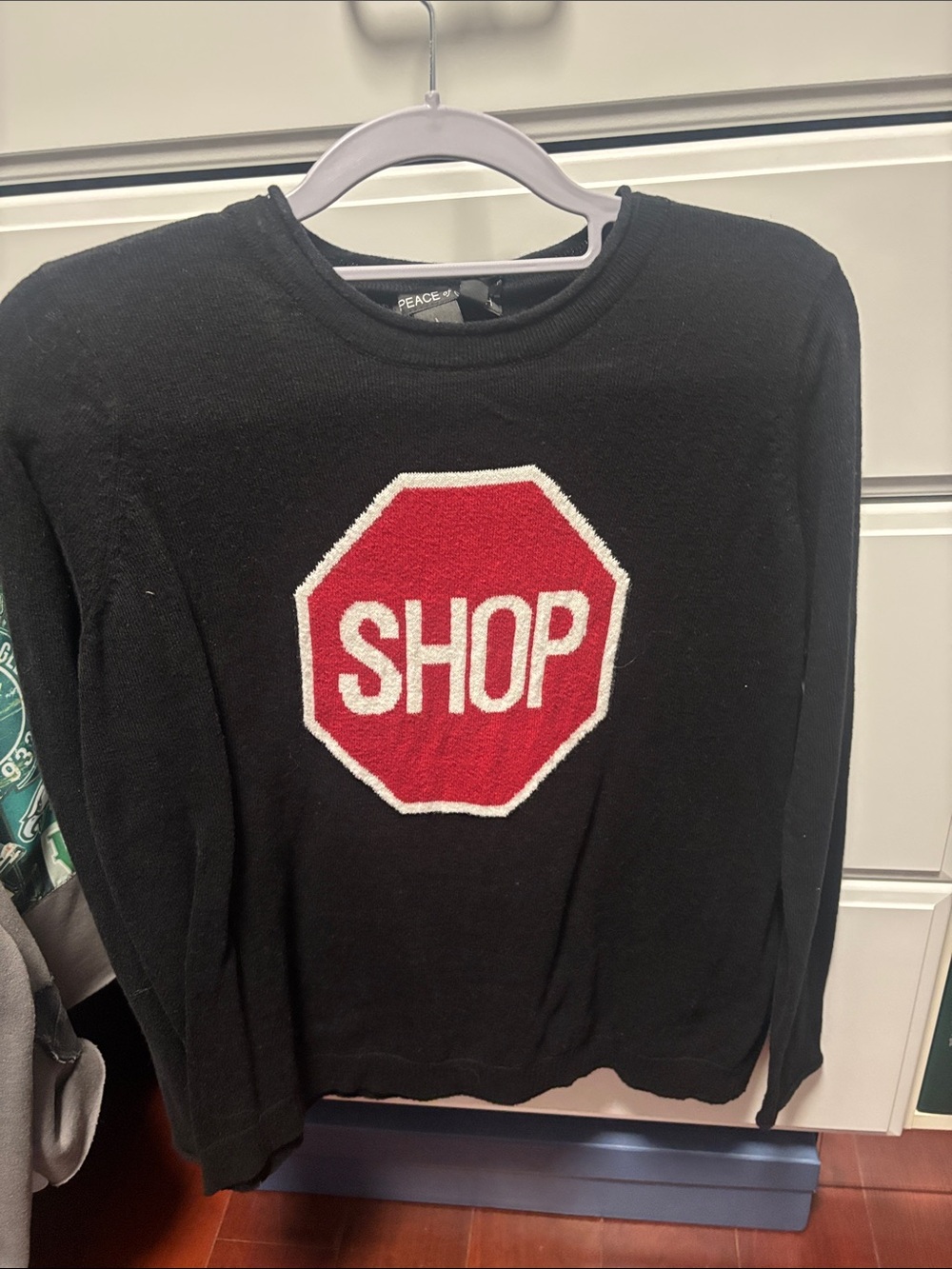 Peace of Cloth Black Crewneck Sweater with Red Octagon 'SHOP' Graphic